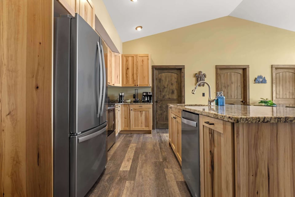 The full kitchen on the upper level is fully equipped for all your culinary needs, featuring a spacious layout, a dedicated coffee station with drip, Keurig, and Nespresso machines, and island seating perfect for socializing while you prepare meals.