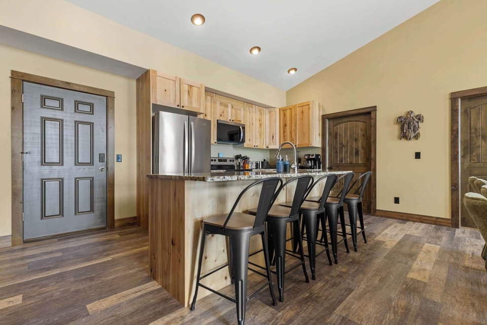 The kitchen island features additional bar-style seating, perfect for casual dining or keeping the chef company while preparing meals.