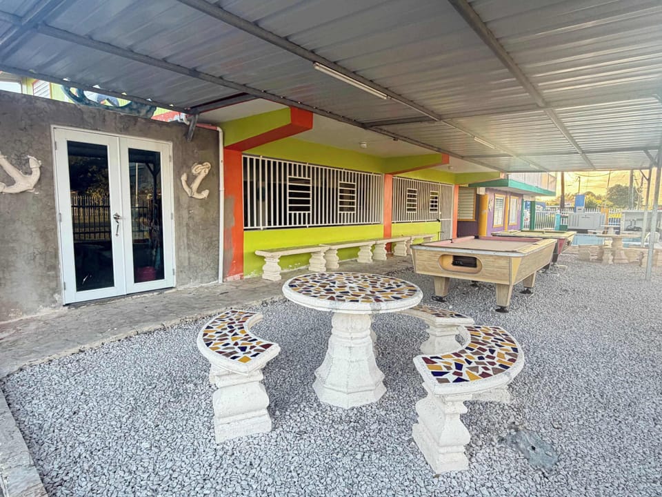 Relax and play in our spacious covered outdoor area, featuring a pool table.