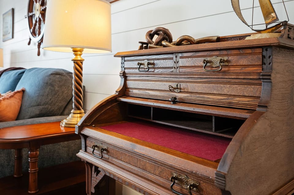 Find focus or relax with a book in this unique vintage secretary desk nook. 📖