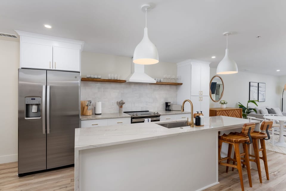 Cook together in your spacious modern kitchen featuring gleaming countertops, premium appliances, and a welcoming breakfast bar for memorable meals.