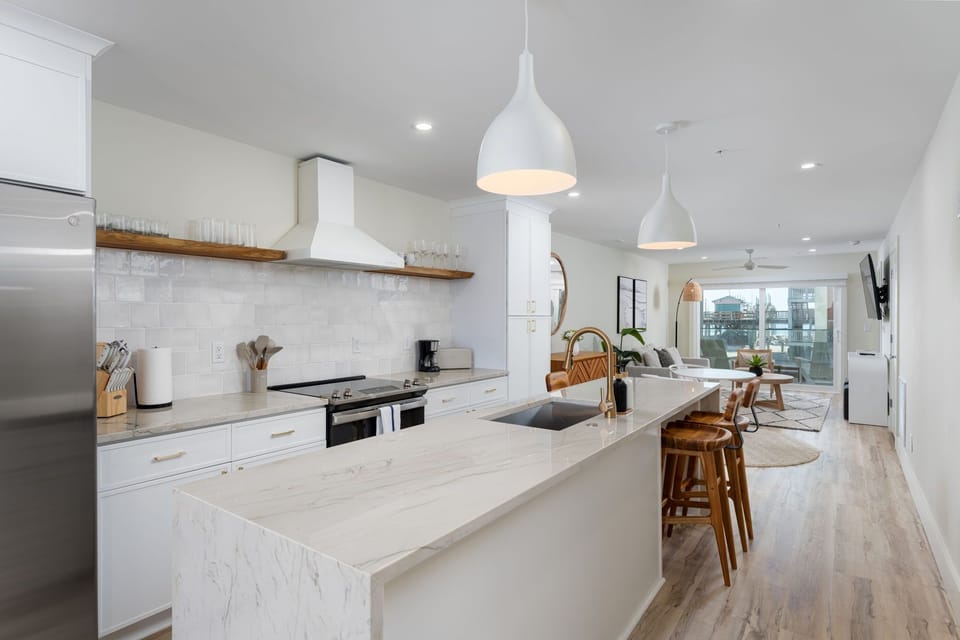 Your sleek modern kitchen features marble countertops, premium appliances, and warm pendant lighting, creating the perfect space for culinary adventures.