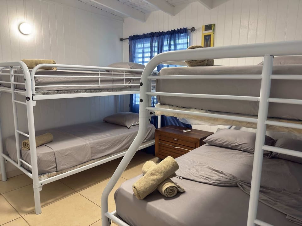Second bedroom with two bunk beds, prepared with fresh towels, and ideal for group stays.