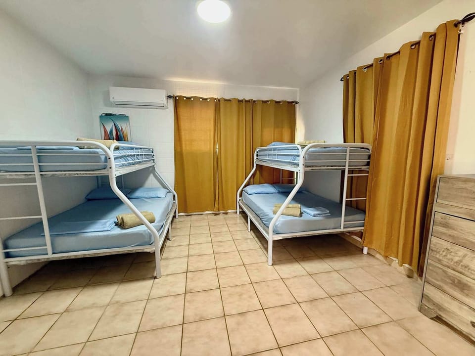 Plenty of sleeping space in this cozy room, featuring two bunk beds and ample storage.