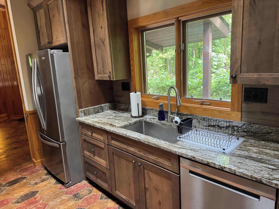 View of gourmet eat-in kitchen in the Peninsula Lakehouse.  This is a bi-level open floor plan with continuous views of the lake and follows the contour of the lots' peninsula shoreline.