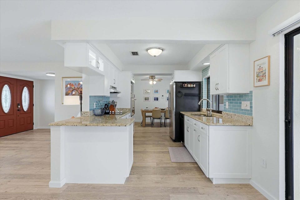 Bright, fully-equipped kitchen overlooking the pool and canal