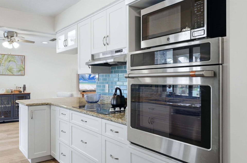 Bright, fully-equipped kitchen overlooking the pool and canal