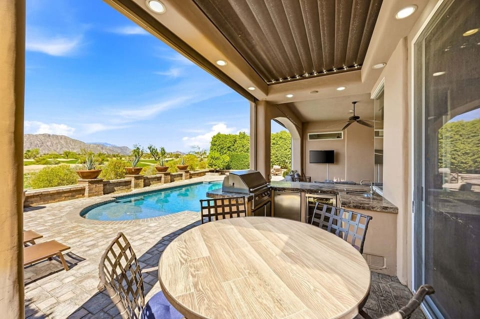 Fully equipped outdoor dining area with grill and shaded seating!
