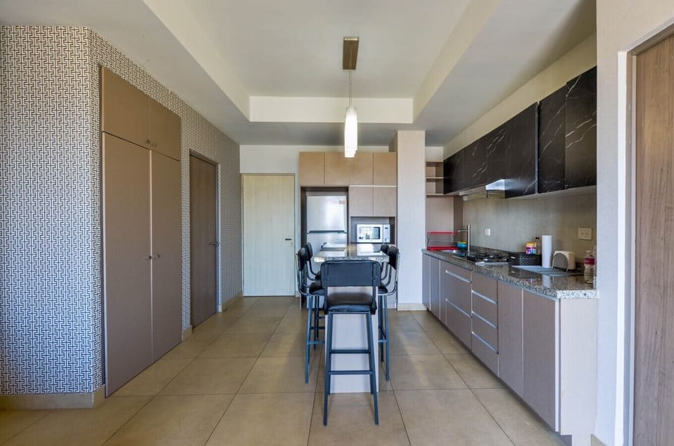 Cocina equipada con estufa, microondas, refrigerador y todos los utensilios necesarios para preparar tus comidas con facilidad.