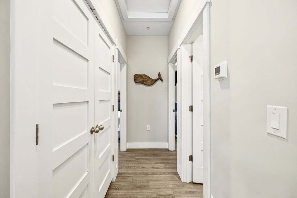 The main-level hallway provides easy access to bedrooms, bathrooms, and living spaces, creating a functional and well-connected flow throughout the home.