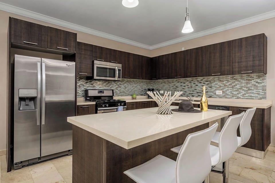The kitchen, equipped with state-of-the-art appliances and ample counter space, is perfect for whipping up gourmet meals or quick snacks.