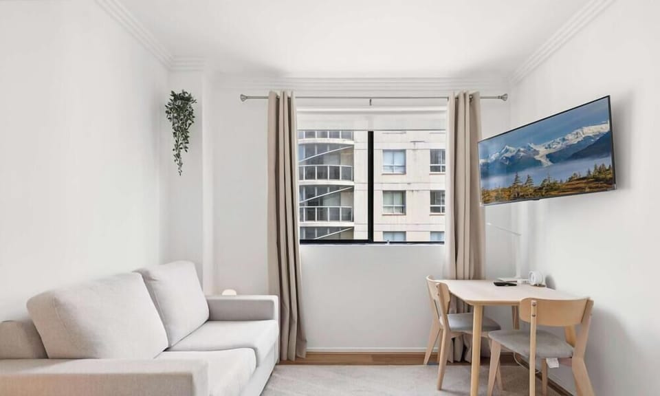 Bright living space with TV and dining nook
