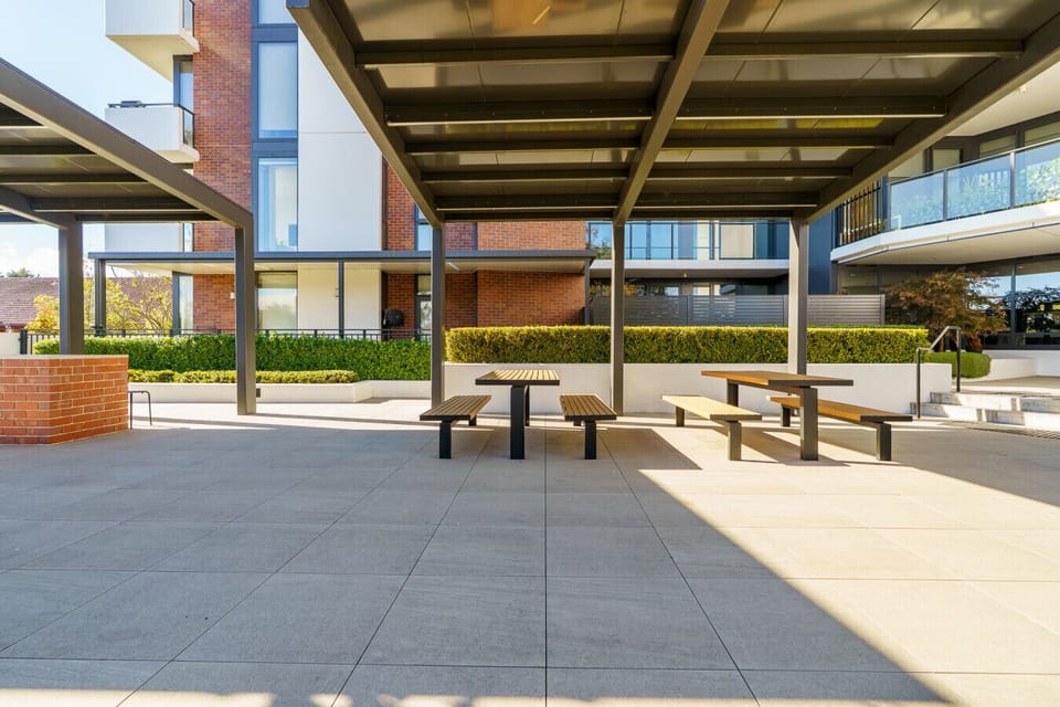 Relax in the spacious outdoor communal area with shaded seating and a welcoming community feel.
