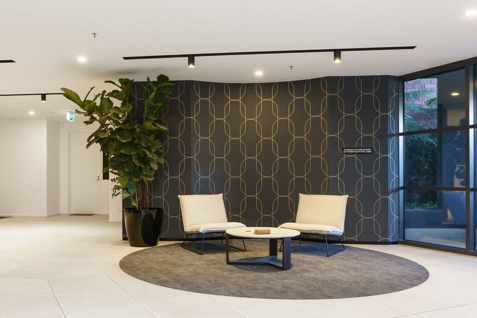Elegant apartment lobby with modern finishes and comfortable seating, creating a warm welcome from the moment you arrive.
