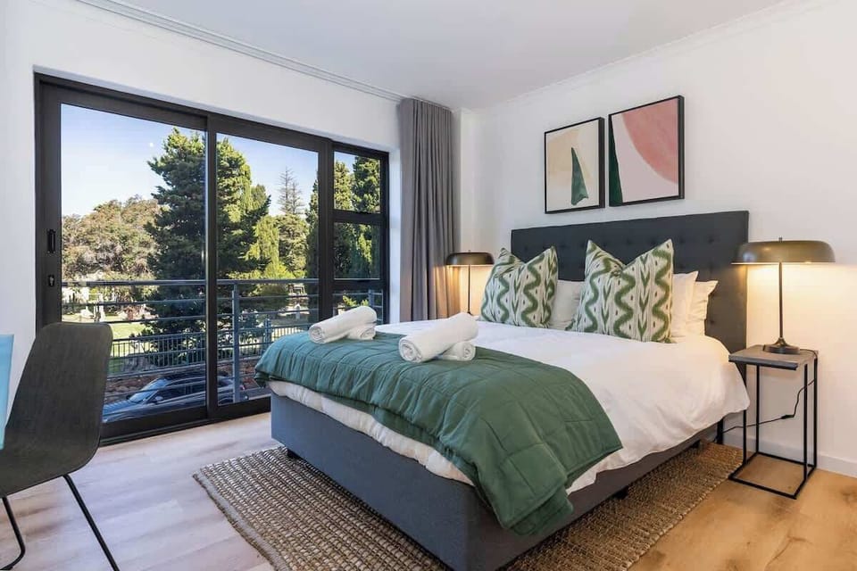A bedroom to relax in, with queen extra length bed covered in quality linen