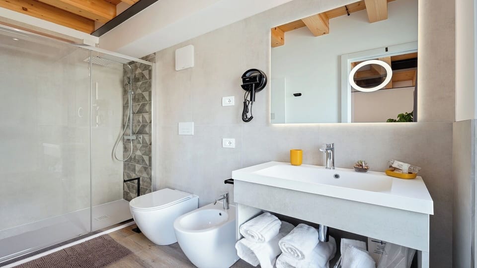 Family Quadruple Room, Garden View | Bathroom | Shower, hair dryer, bidet, towels