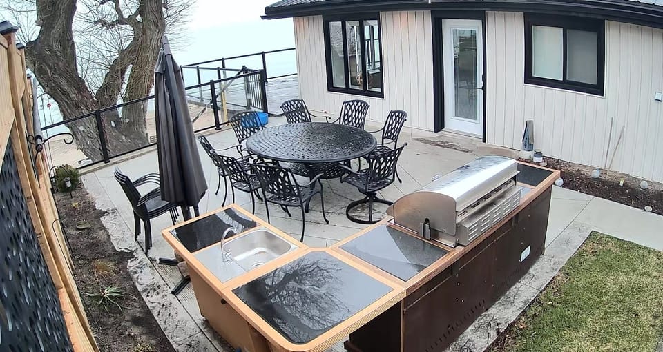 Exterior patio with BBQ, lots of seating and shade.