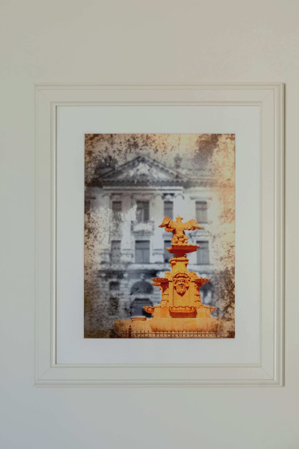 A framed artwork hanging on a light-colored wall. The piece adds a subtle decorative touch to the interior.