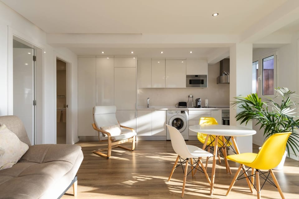 Modern and functional kitchen area with countertops, built-in appliances, and access to the dining area and terrace