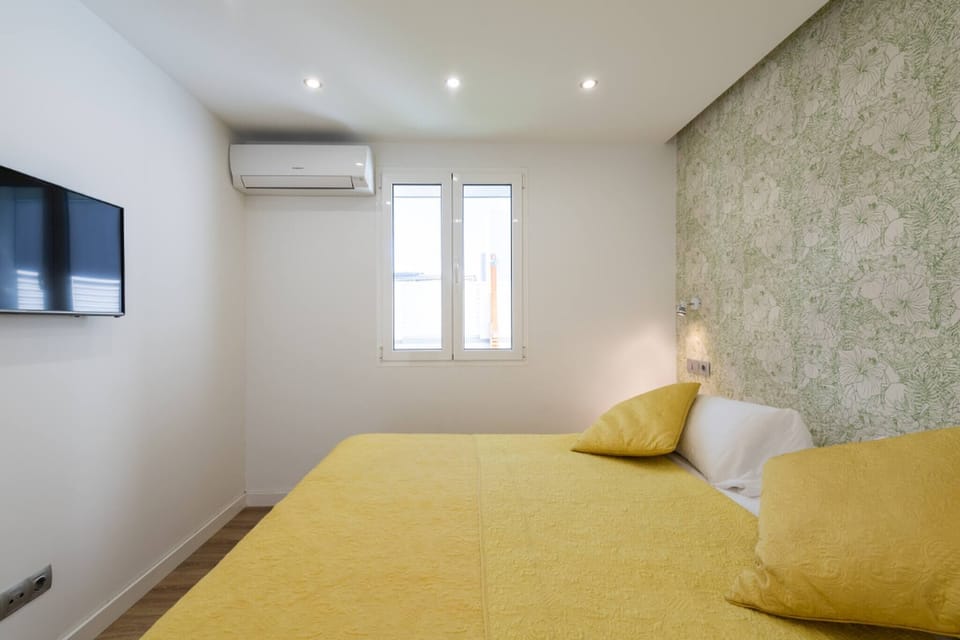 Bedroom with TV, and air conditioning, ensuring comfort and entertainment during your stay
