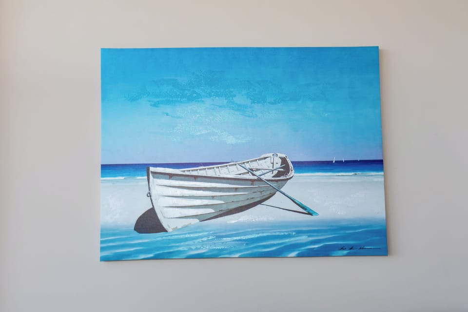 Admire beautiful coastal artwork that brings tranquil seaside vibes to your relaxing retreat.