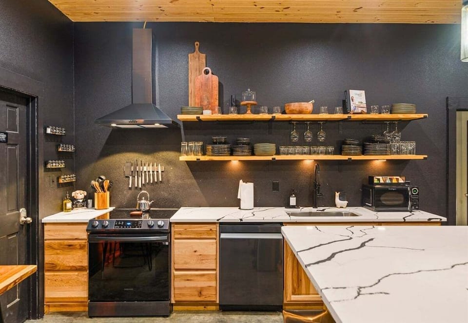 Open shelving and sleek finishes give this kitchen a modern edge, while still feeling cozy and functional for everything from pancake breakfasts to late-night snacks.