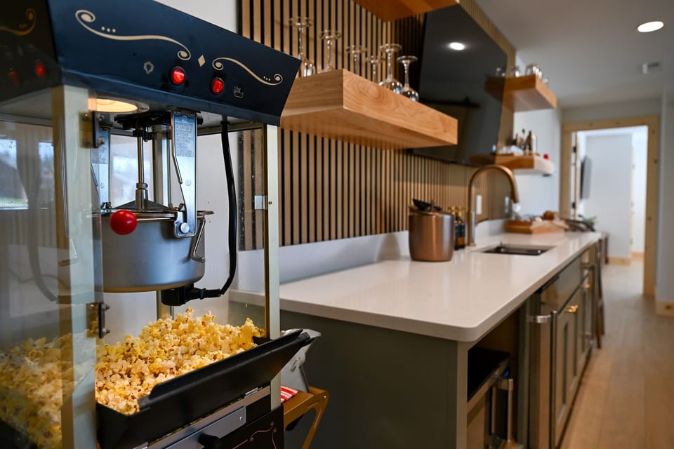 Enjoy your own popcorn machine, located by the wet bar, for your movie nights, out by the firepit, or just general snacking!