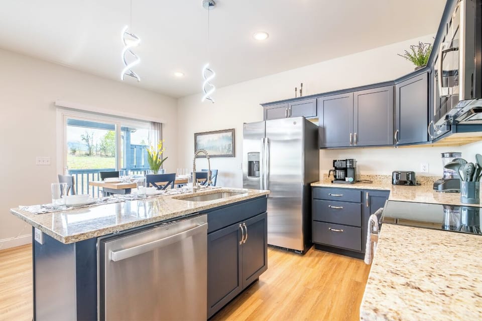 Your gourmet kitchen awaits with granite counters, stainless appliances, and an island perfect for morning coffee or evening wine.