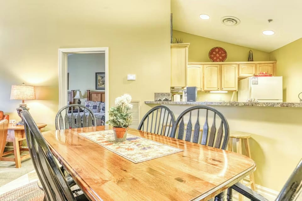 Gather around this welcoming dining table where your meals become memories, with an open kitchen ready for your culinary adventures.