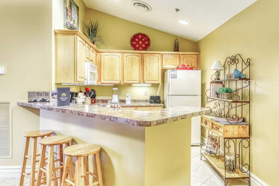 Your fully equipped kitchen features granite counters, bar seating, and everything needed to prepare memorable meals during your stay.