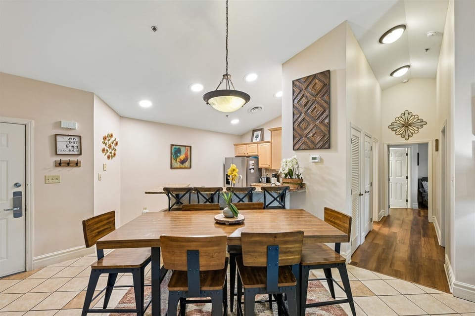 Gather around this warm dining table where conversations flow and meals become memories in your home away from home.