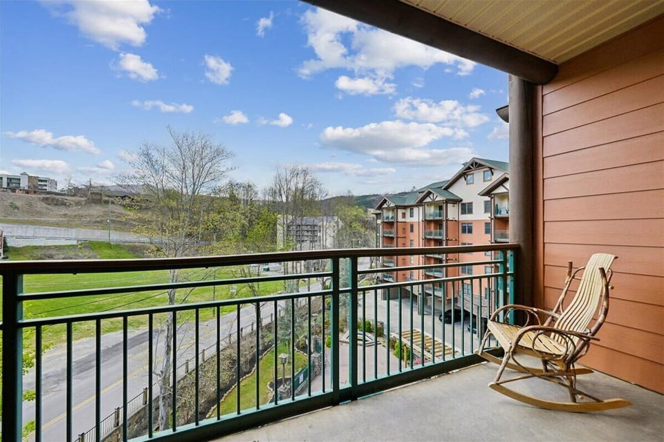 Your private balcony offers peaceful views of rolling hills and nearby buildings, perfect for morning coffee in the rocking chair.
