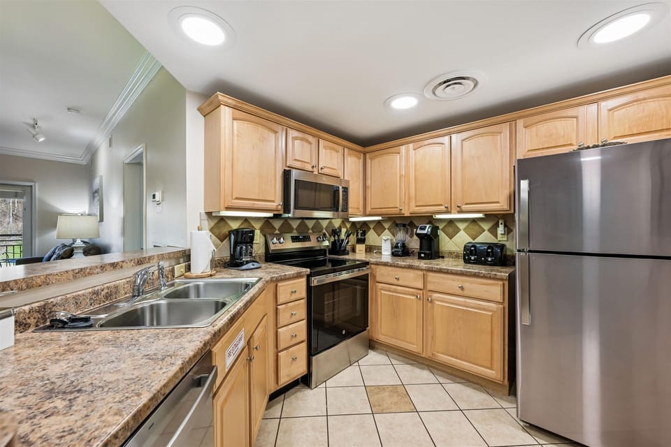 Your fully equipped kitchen awaits with granite countertops, stainless steel appliances, and all the essentials for memorable meals.