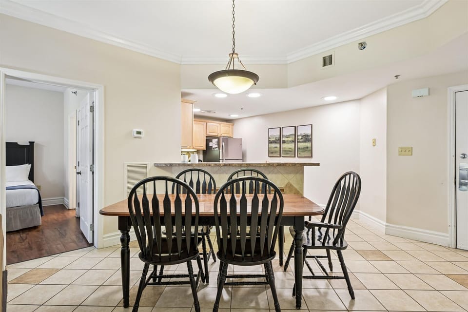 Gather around your spacious dining table where memorable meals and conversations flow naturally. The open layout connects you to the kitchen for easy entertaining.