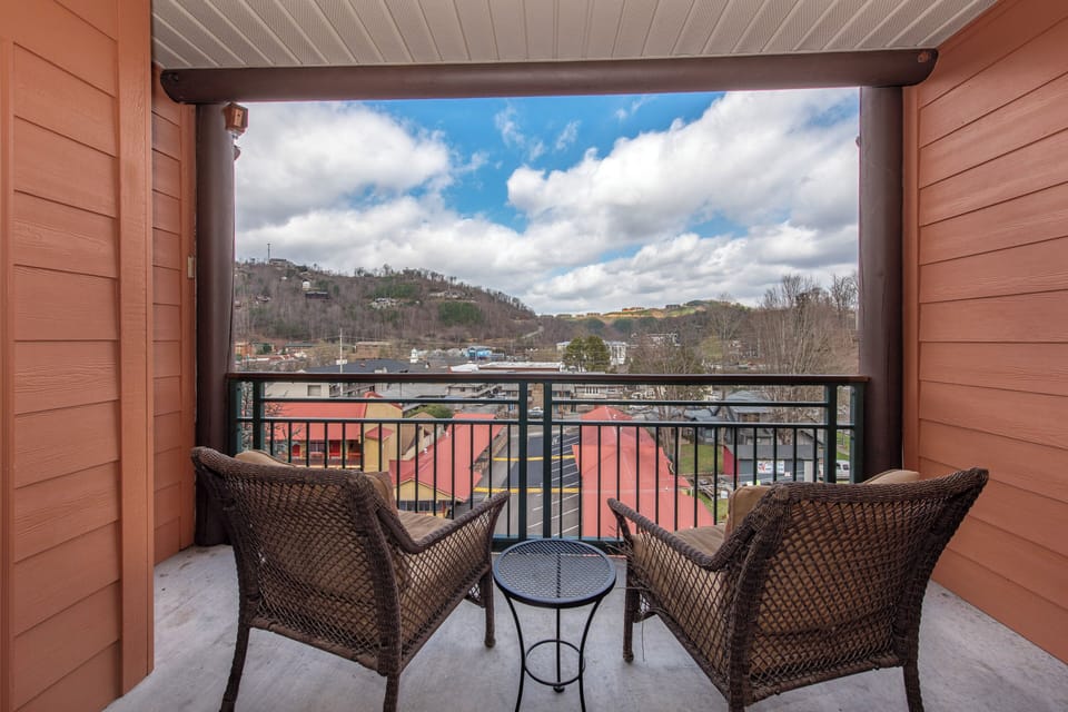 Unwind on your private balcony with wicker seating while taking in sweeping mountain views and charming town scenery below.
