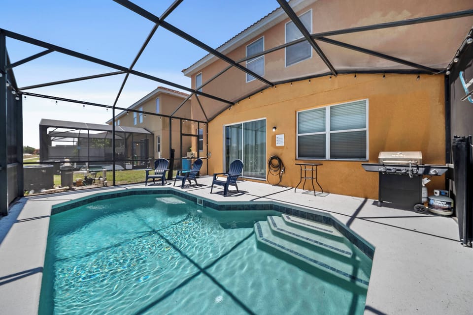 Step outside to your private pool area, where shimmering turquoise waters invite you to relax. Enjoy lazy afternoons on comfy lounge chairs, surrounded by a stylish deck and a luxurious protected lanai for your perfect getaway.