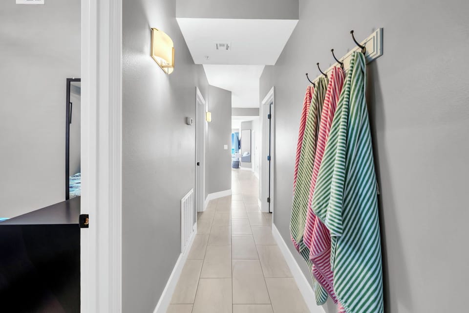 Fresh towels await your arrival in this bright, modern hallway connecting your comfortable spaces.