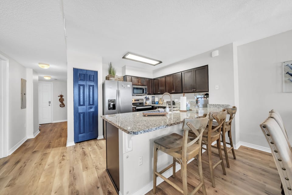 You'll love the bright, open-plan kitchen with granite countertops and stainless steel appliances. Gather around the island for casual meals or relax in the adjoining living space.