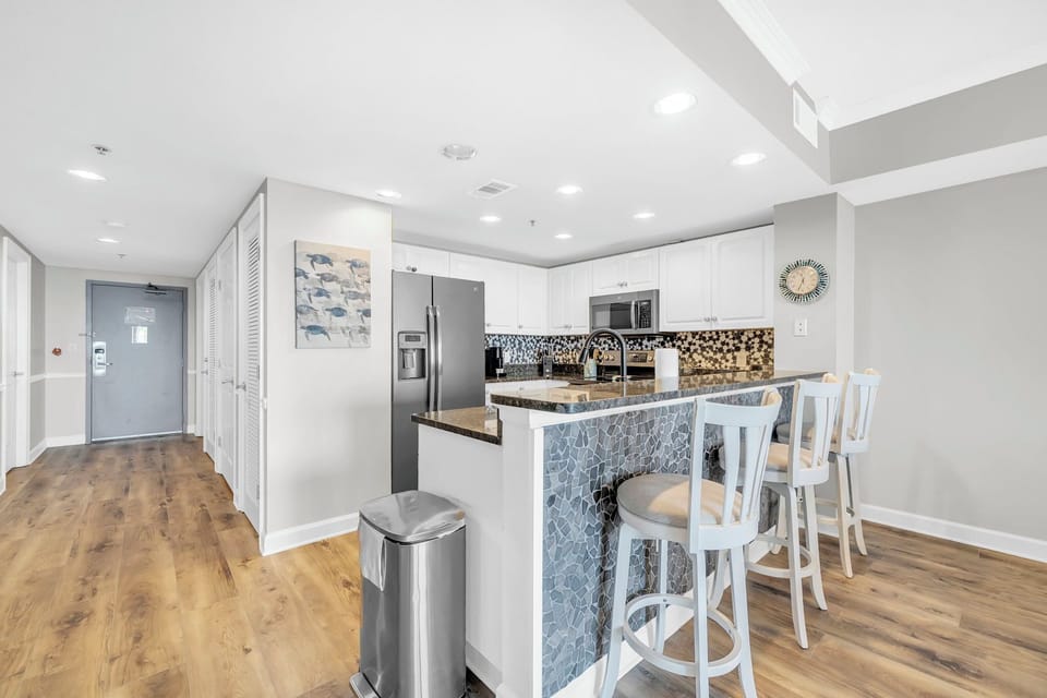 Your spacious kitchen features modern appliances and a stylish breakfast bar where you can enjoy morning coffee.