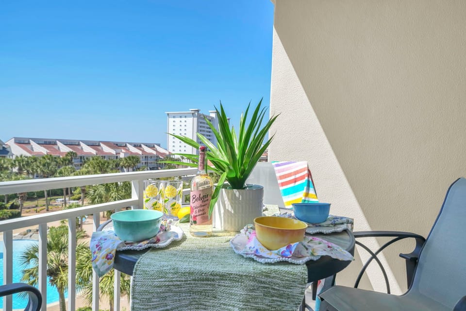 Sip your morning coffee on your private balcony while enjoying tropical views of palm trees and the neighborhood below.