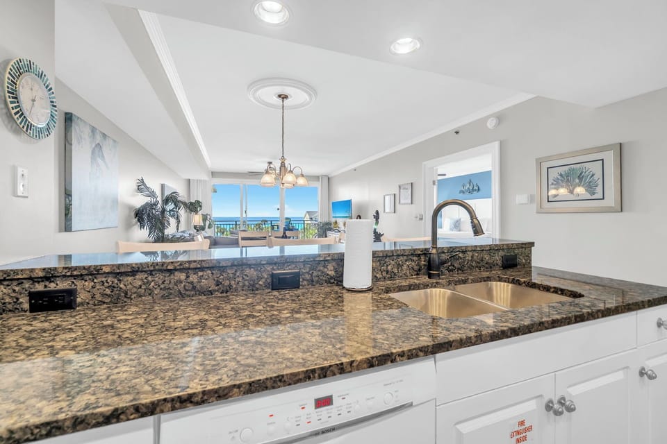 Rinse and refresh with a kitchen view that opens to bright coastal living beyond.