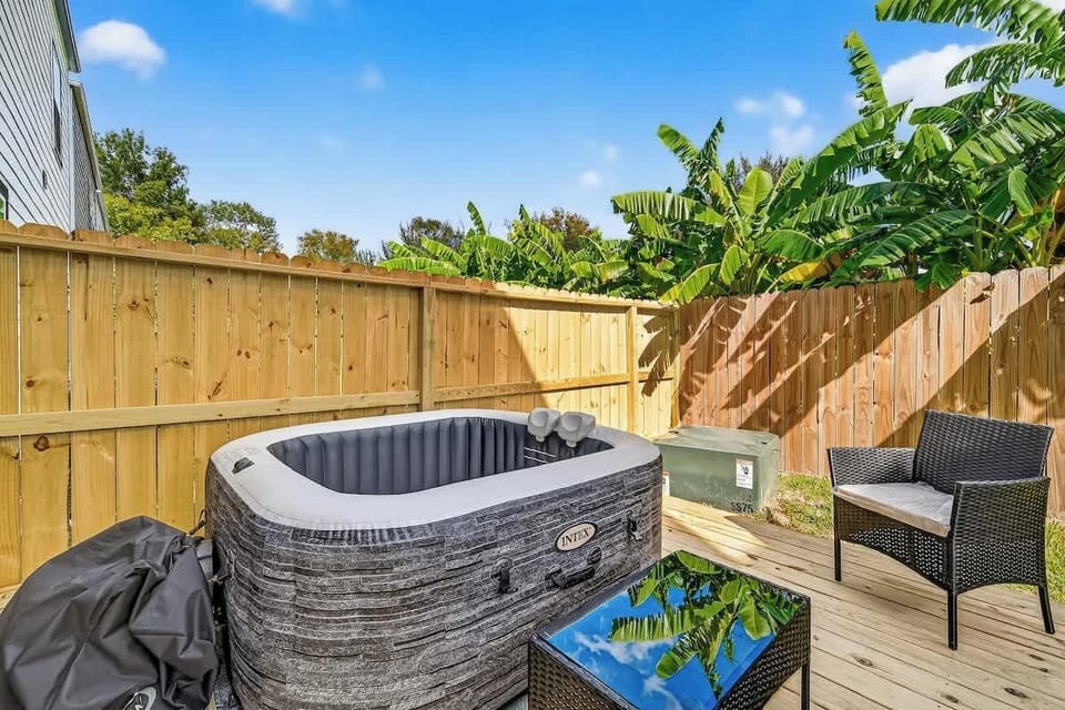 Backyard Oasis: Dive into relaxation in your private hot tub surrounded by lush greenery!