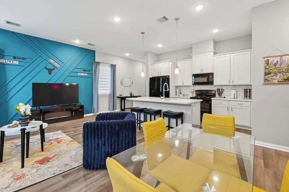 Dining Area: Vibrant yellow chairs and stylish decor create the perfect backdrop for meals and laughs!
