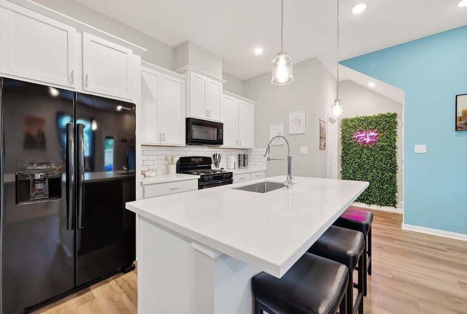 Kitchen Paradise: Sleek whites and blacks create a chic space for culinary adventures and gatherings!