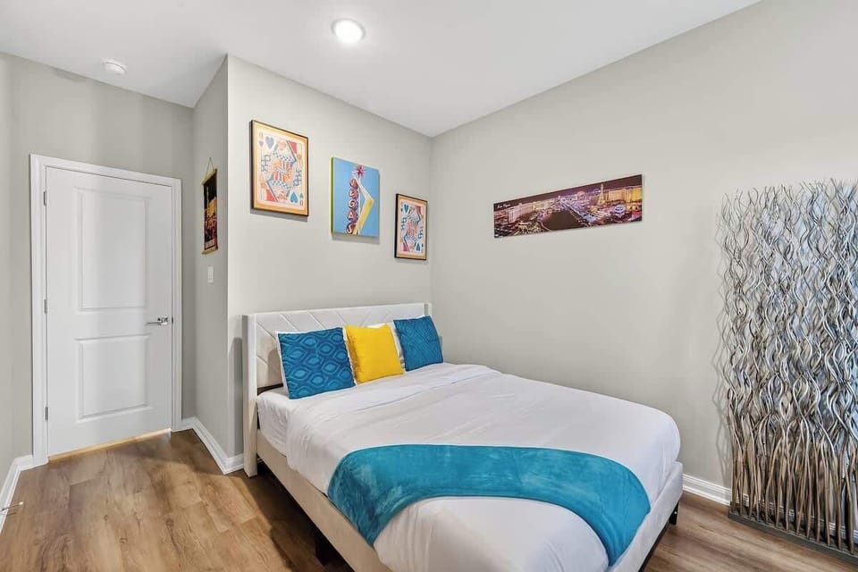 Guest Room: Vibrant art, plush queen bed, and modern charm for your Houston getaway!