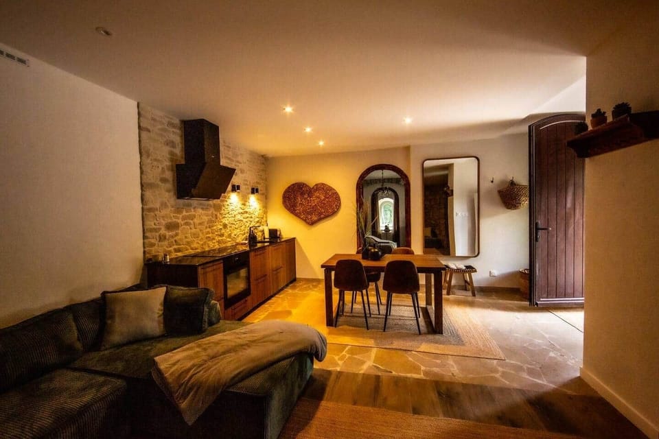 Open living area with lounge, dining space, and kitchen leading out to the courtyard