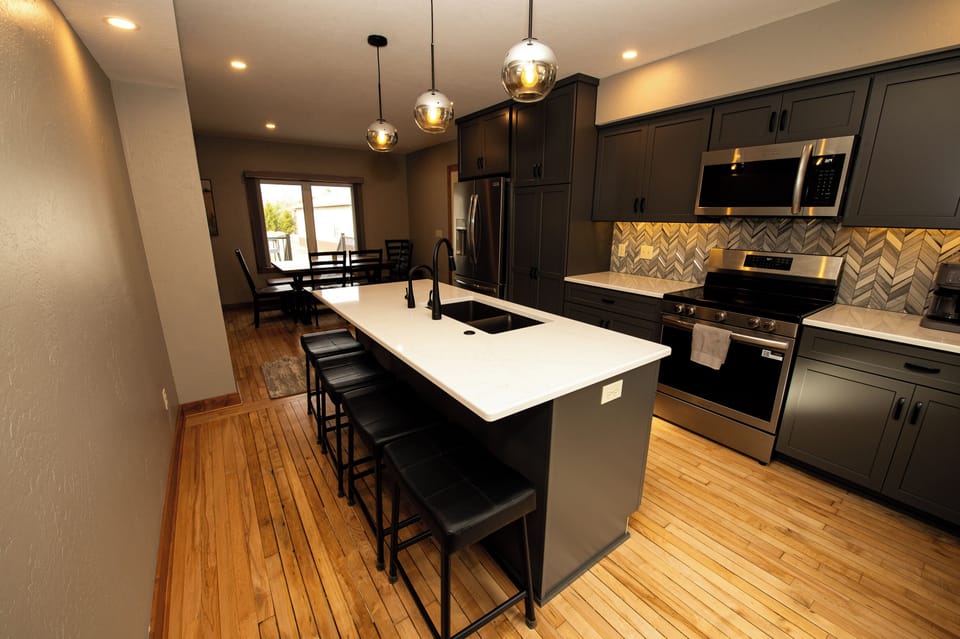 Kitchen with counter seating for 4 and dining area for seating for 8