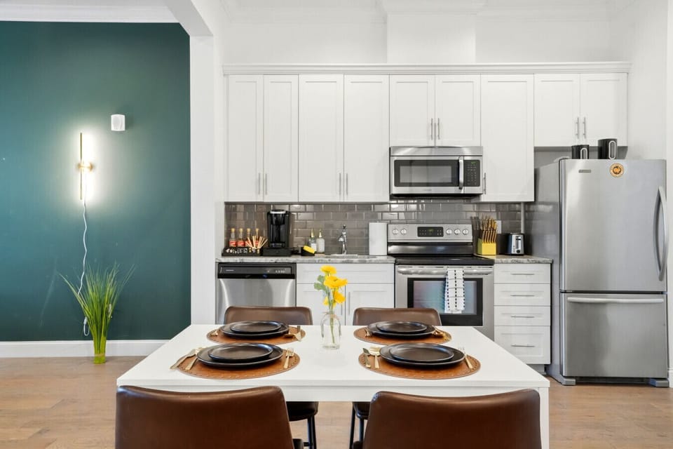 Dining area and open concept, fully equipped kitchen with stainless steel appliances. Coffee supplies, salt, pepper, and olive oil are provided for our guests