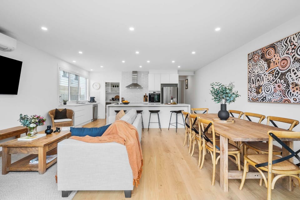 Elegant open-plan living, dining and kitchen with island seating