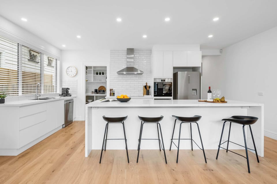 Light and bright kitchen with large island and bar seating